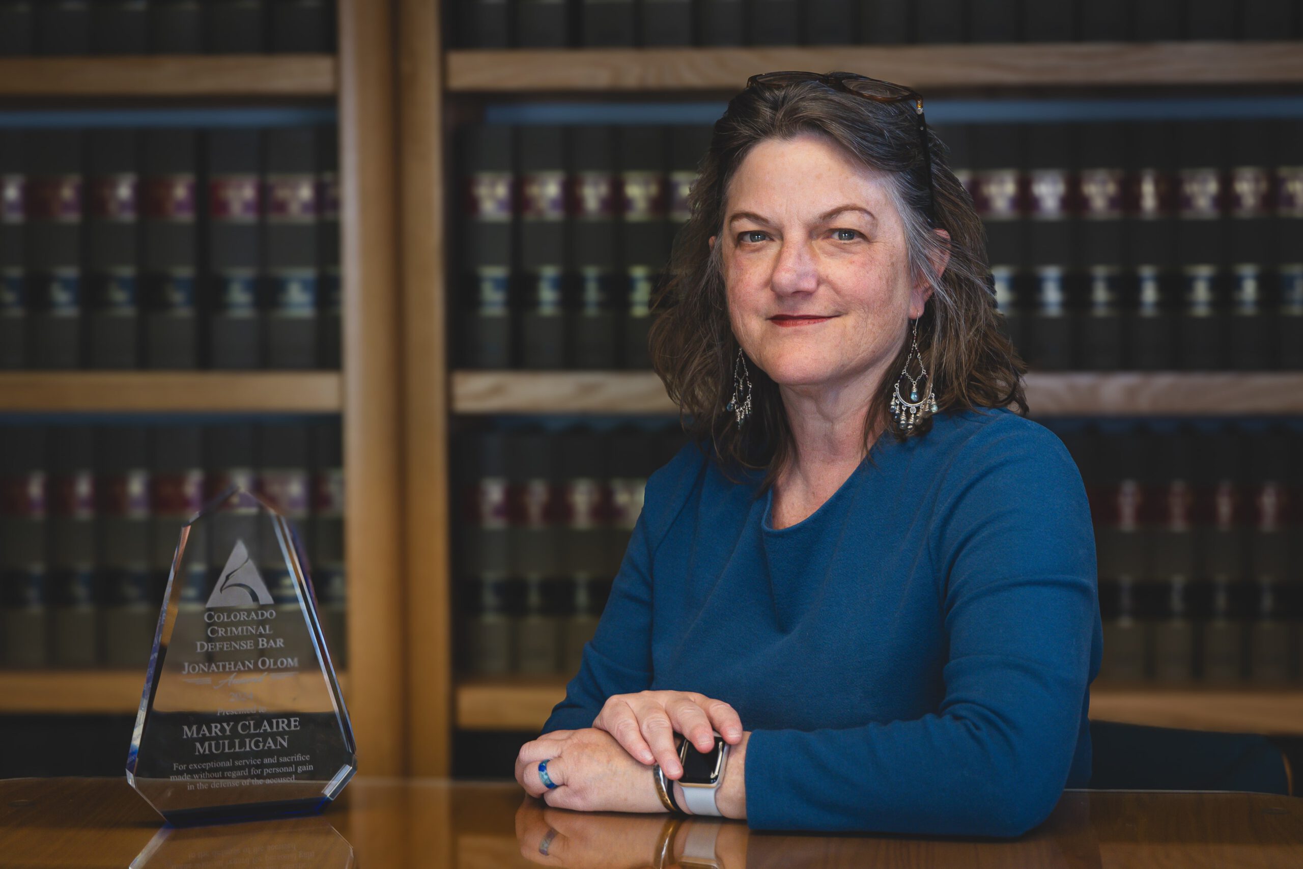 mary claire mulligan with Olum award at desk